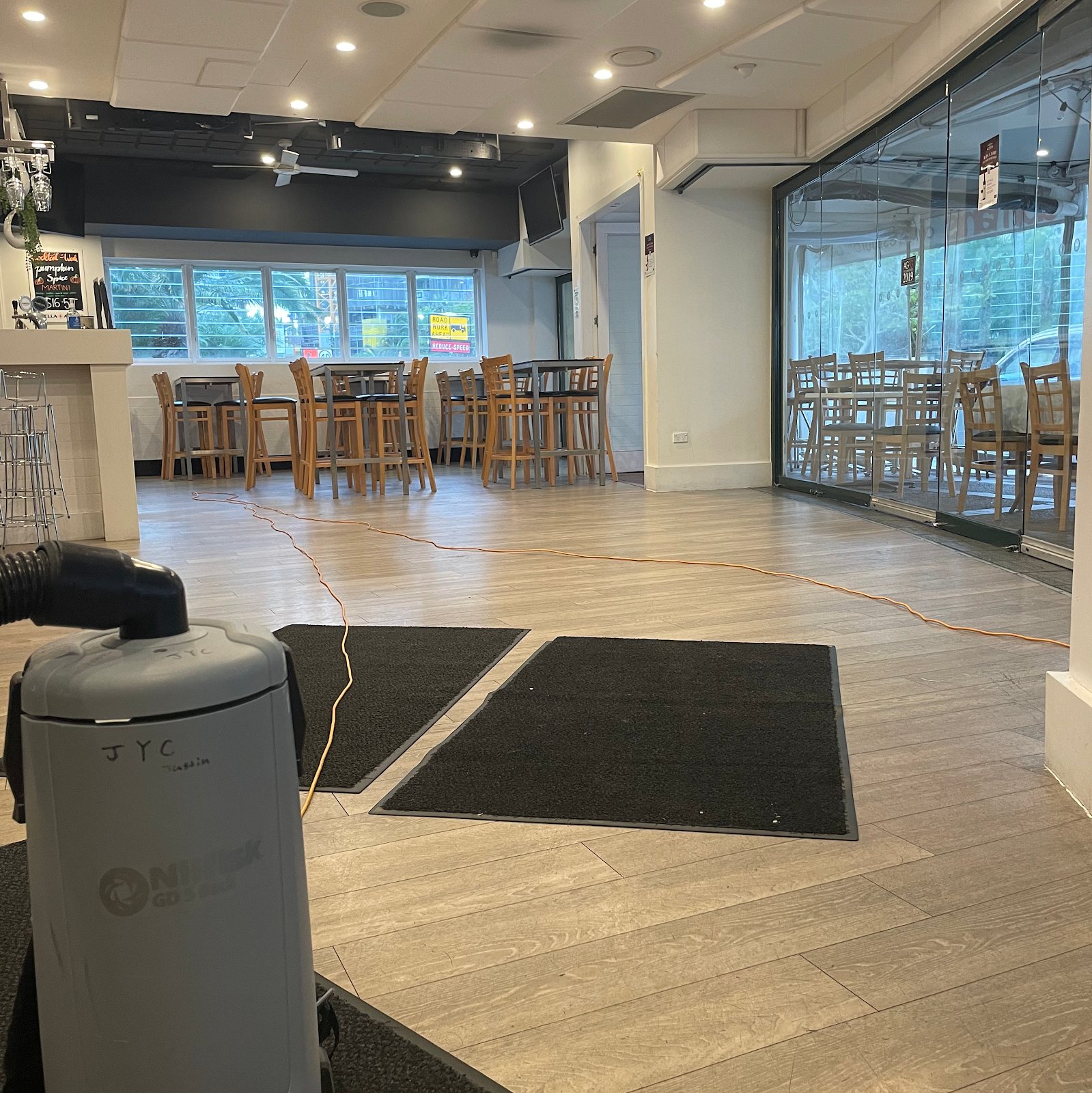 Backpack vacuum in a bar with timber floors