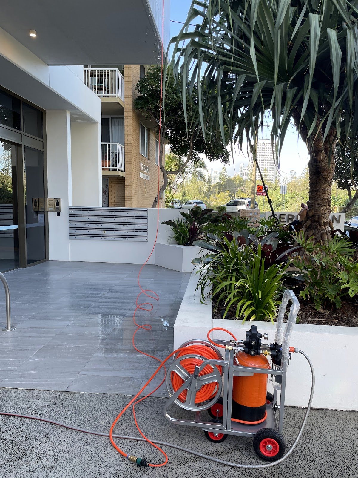 Pressure-washing rig at an apartment building entrance