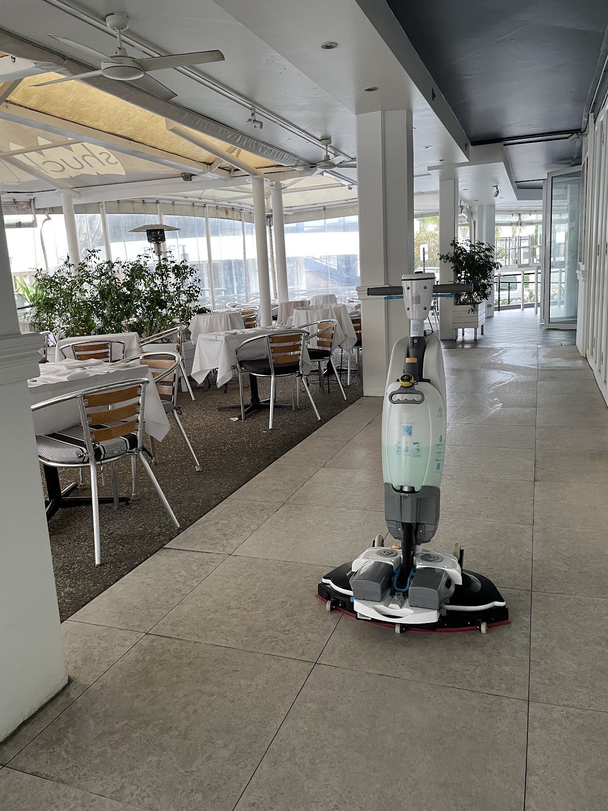 Scrubber-dryer on the tiled terrace of a restaurant