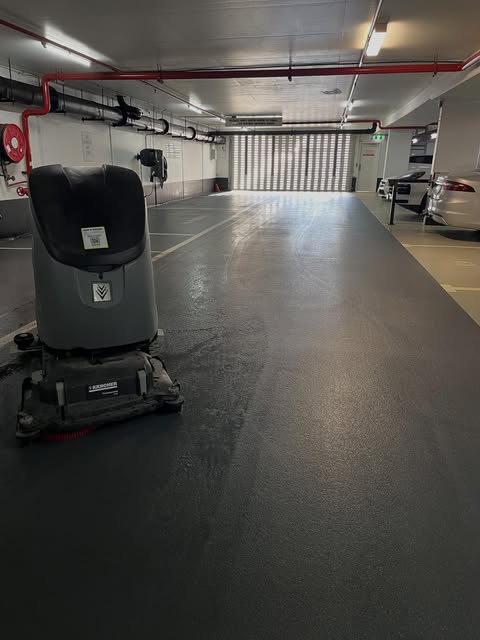 Ride-on scrubber on a freshly cleaned underground car park floor