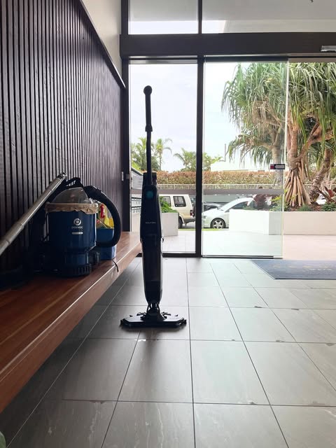 Floor washer in a tiled apartment lobby